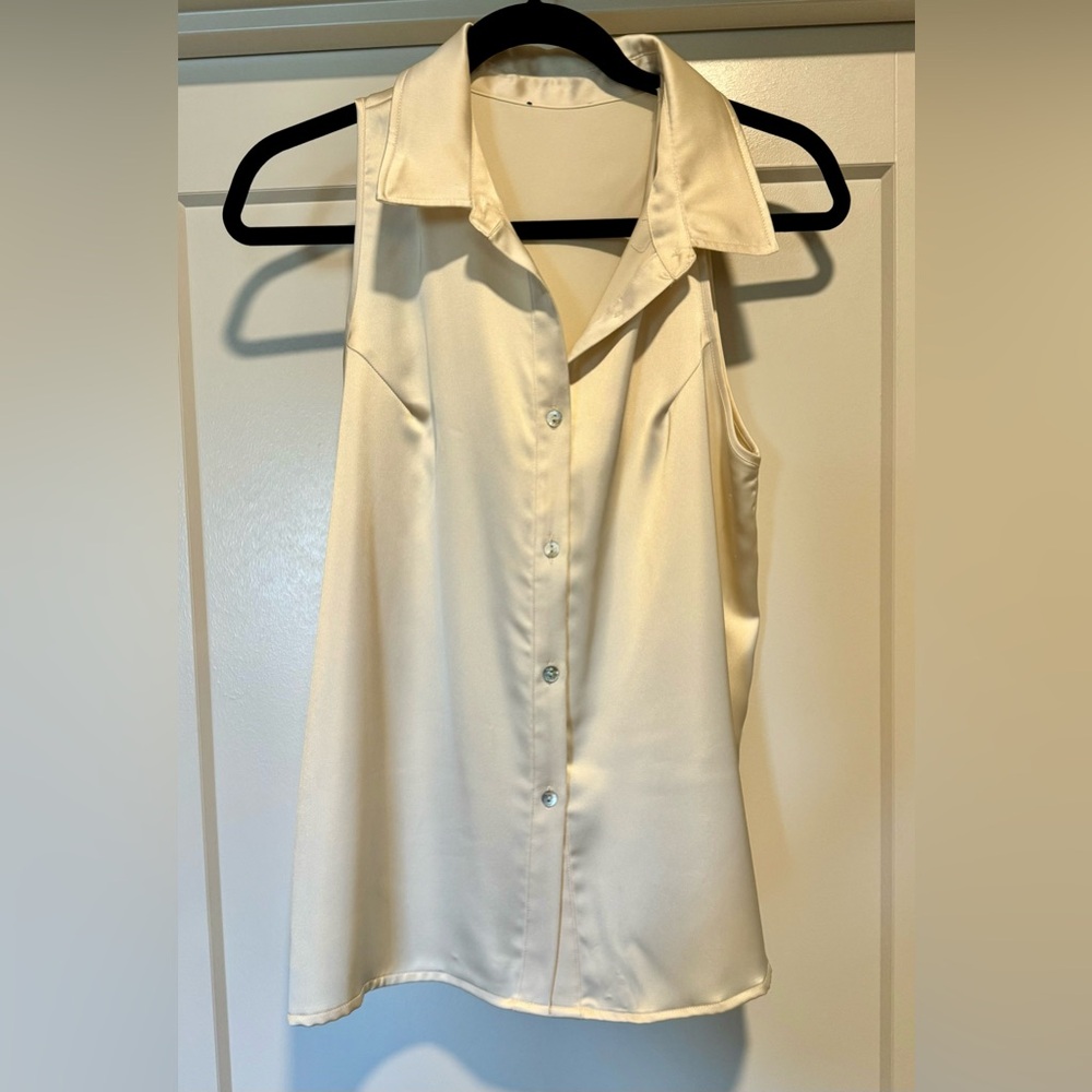 Satin finish cream coloured sleeveless blouse